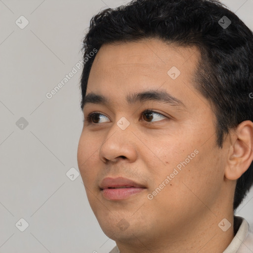 Joyful asian young-adult male with short  black hair and brown eyes