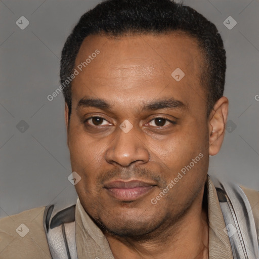 Joyful latino adult male with short  black hair and brown eyes