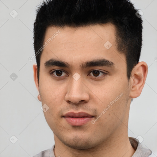 Joyful latino young-adult male with short  black hair and brown eyes