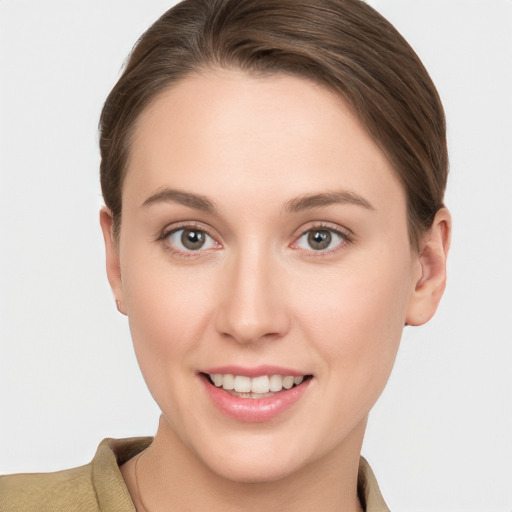 Joyful white young-adult female with short  brown hair and grey eyes