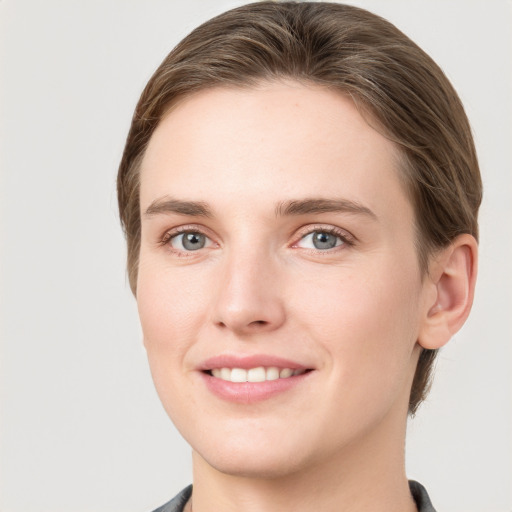 Joyful white young-adult female with medium  brown hair and grey eyes