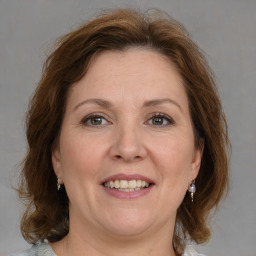 Joyful white adult female with medium  brown hair and grey eyes