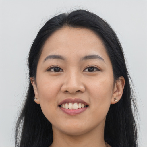 Joyful asian young-adult female with long  black hair and brown eyes