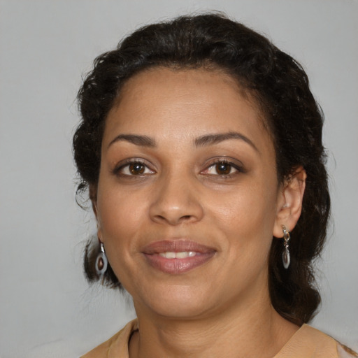 Joyful latino adult female with medium  brown hair and brown eyes