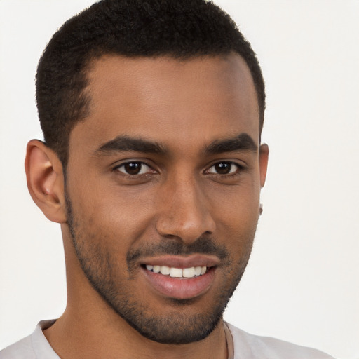 Joyful black young-adult male with short  brown hair and brown eyes