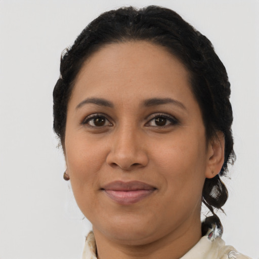Joyful latino adult female with short  brown hair and brown eyes