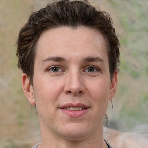 Joyful white adult male with short  brown hair and grey eyes