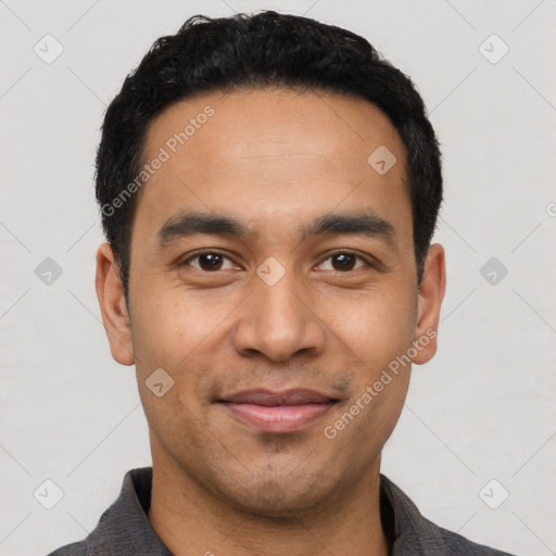 Joyful latino young-adult male with short  black hair and brown eyes