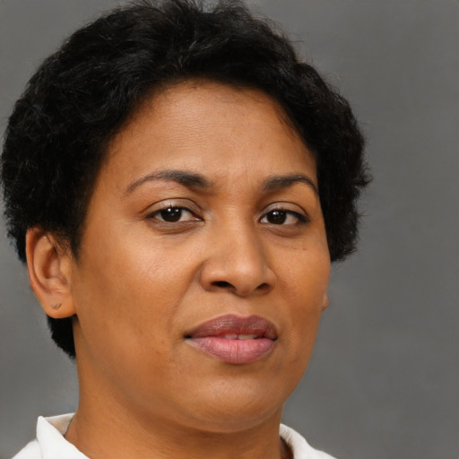 Joyful latino adult female with short  brown hair and brown eyes