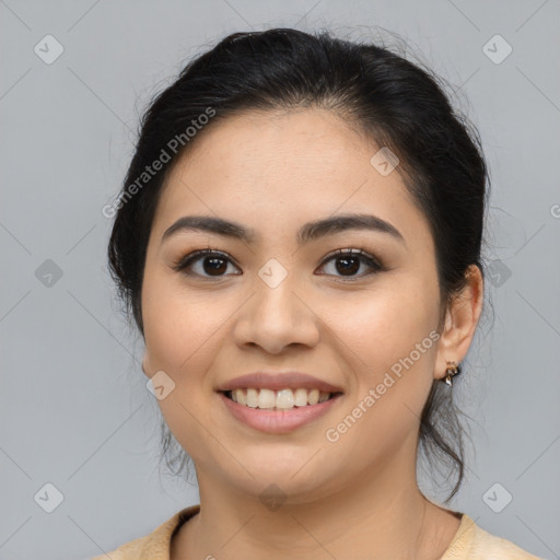 Joyful latino young-adult female with medium  brown hair and brown eyes