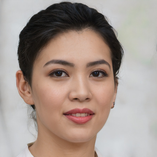 Joyful asian young-adult female with medium  brown hair and brown eyes