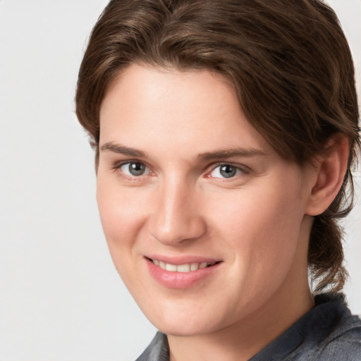 Joyful white young-adult female with medium  brown hair and grey eyes