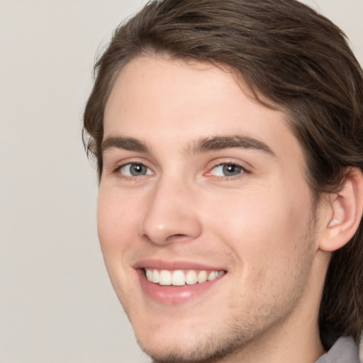 Joyful white young-adult male with medium  brown hair and brown eyes