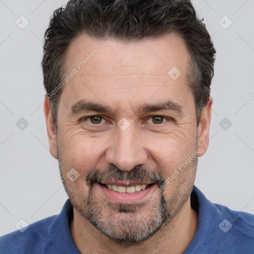 Joyful white adult male with short  black hair and brown eyes