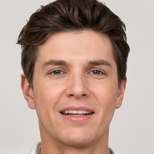 Joyful white adult male with short  brown hair and grey eyes