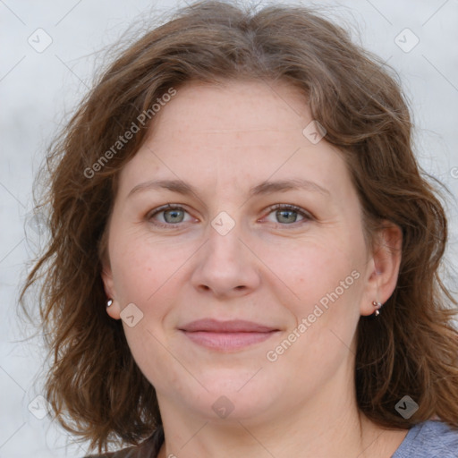 Joyful white adult female with medium  brown hair and blue eyes