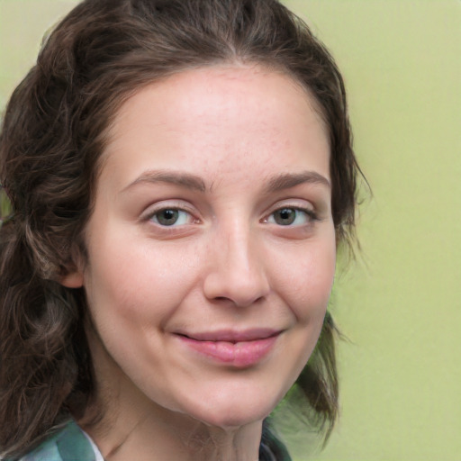 Joyful white young-adult female with long  brown hair and green eyes