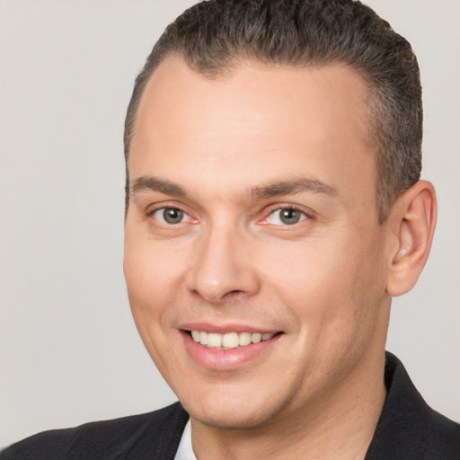 Joyful white adult male with short  brown hair and brown eyes