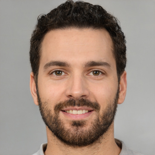 Joyful white young-adult male with short  brown hair and brown eyes