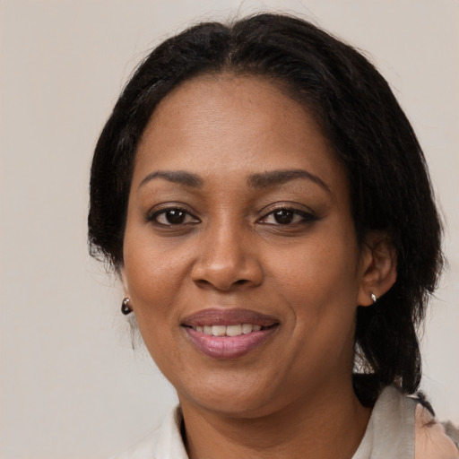 Joyful black adult female with medium  black hair and brown eyes