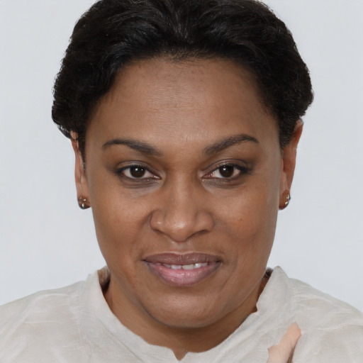 Joyful black adult female with short  brown hair and brown eyes