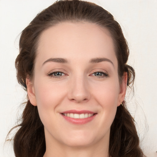 Joyful white young-adult female with long  brown hair and grey eyes