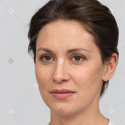 Joyful white adult female with medium  brown hair and brown eyes