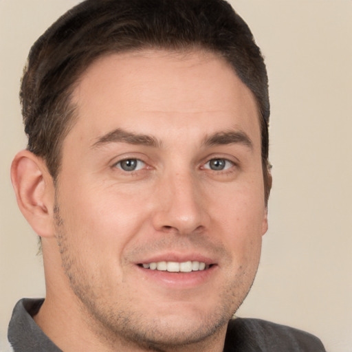 Joyful white young-adult male with short  brown hair and brown eyes