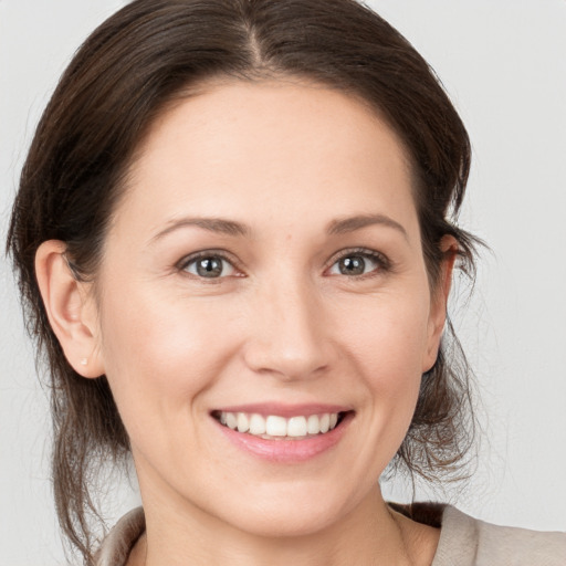 Joyful white young-adult female with medium  brown hair and brown eyes