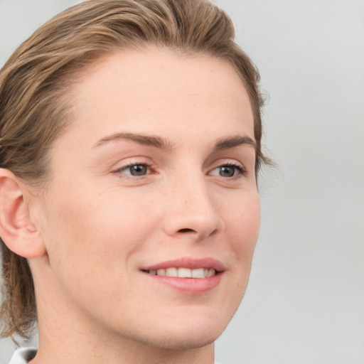 Joyful white young-adult female with medium  brown hair and blue eyes