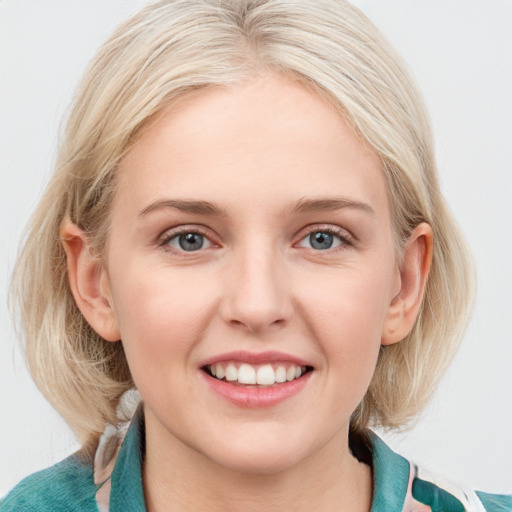 Joyful white young-adult female with medium  blond hair and blue eyes