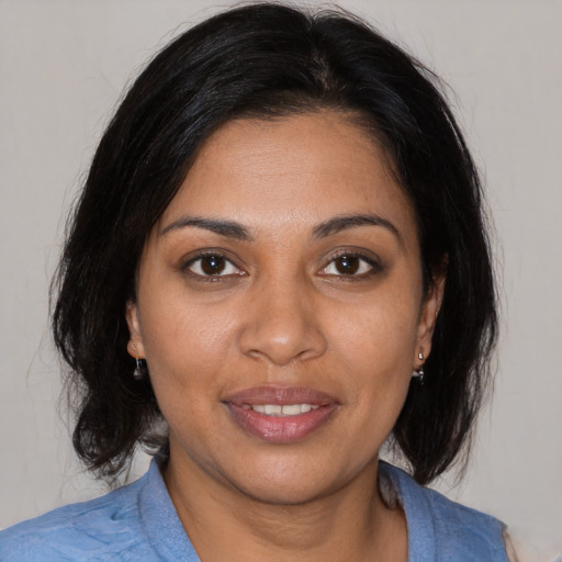 Joyful black young-adult female with medium  brown hair and brown eyes
