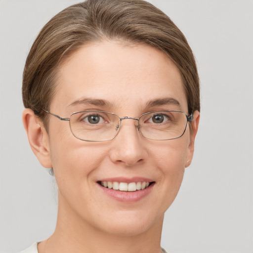 Joyful white adult female with short  brown hair and grey eyes