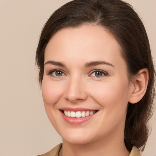 Joyful white young-adult female with medium  brown hair and brown eyes