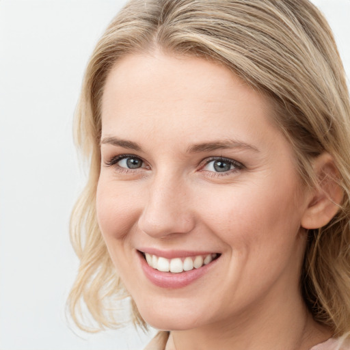 Joyful white young-adult female with medium  brown hair and blue eyes