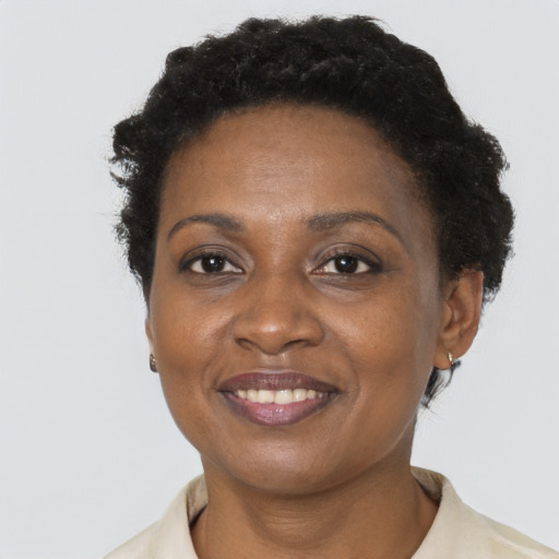 Joyful black adult female with short  brown hair and brown eyes