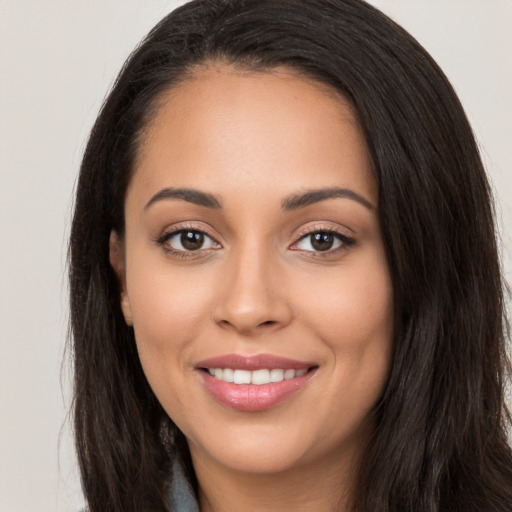 Joyful white young-adult female with long  black hair and brown eyes