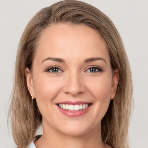 Joyful white young-adult female with long  brown hair and grey eyes