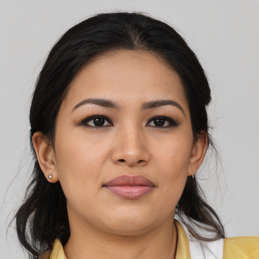 Joyful latino young-adult female with medium  brown hair and brown eyes