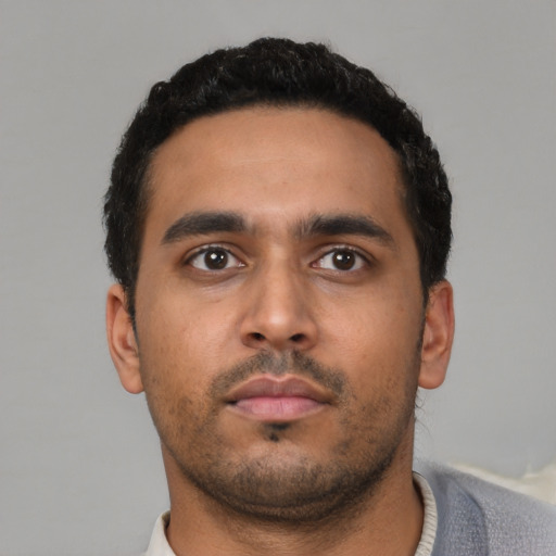 Neutral latino young-adult male with short  black hair and brown eyes