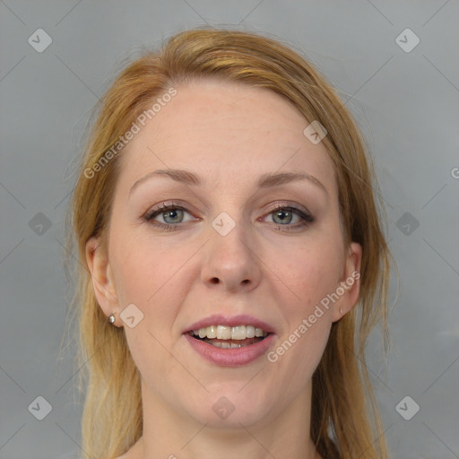 Joyful white adult female with long  brown hair and blue eyes