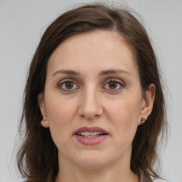 Joyful white adult female with long  brown hair and brown eyes