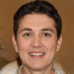 Joyful white adult male with short  brown hair and brown eyes