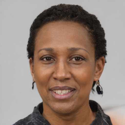 Joyful latino adult female with short  black hair and brown eyes