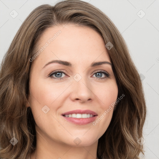 Joyful white young-adult female with long  brown hair and green eyes