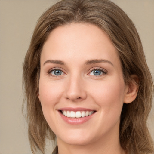 Joyful white young-adult female with medium  brown hair and green eyes