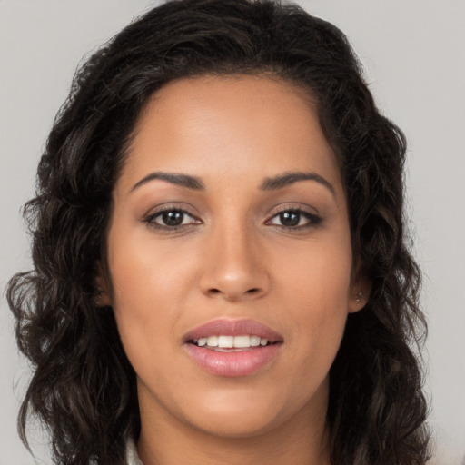 Joyful latino young-adult female with long  brown hair and brown eyes