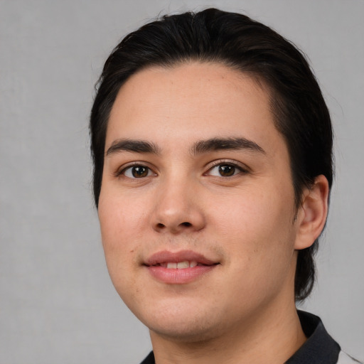 Joyful white young-adult male with medium  black hair and brown eyes