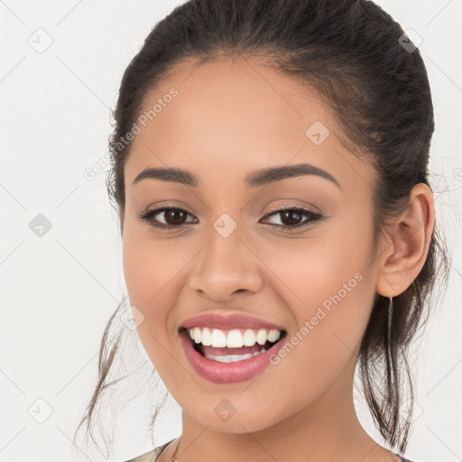 Joyful white young-adult female with long  brown hair and brown eyes