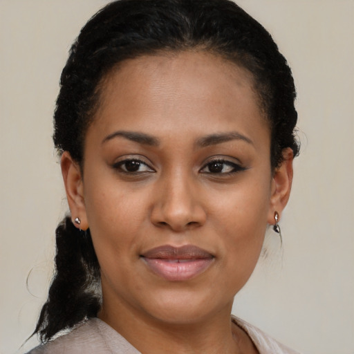 Joyful black young-adult female with short  brown hair and brown eyes